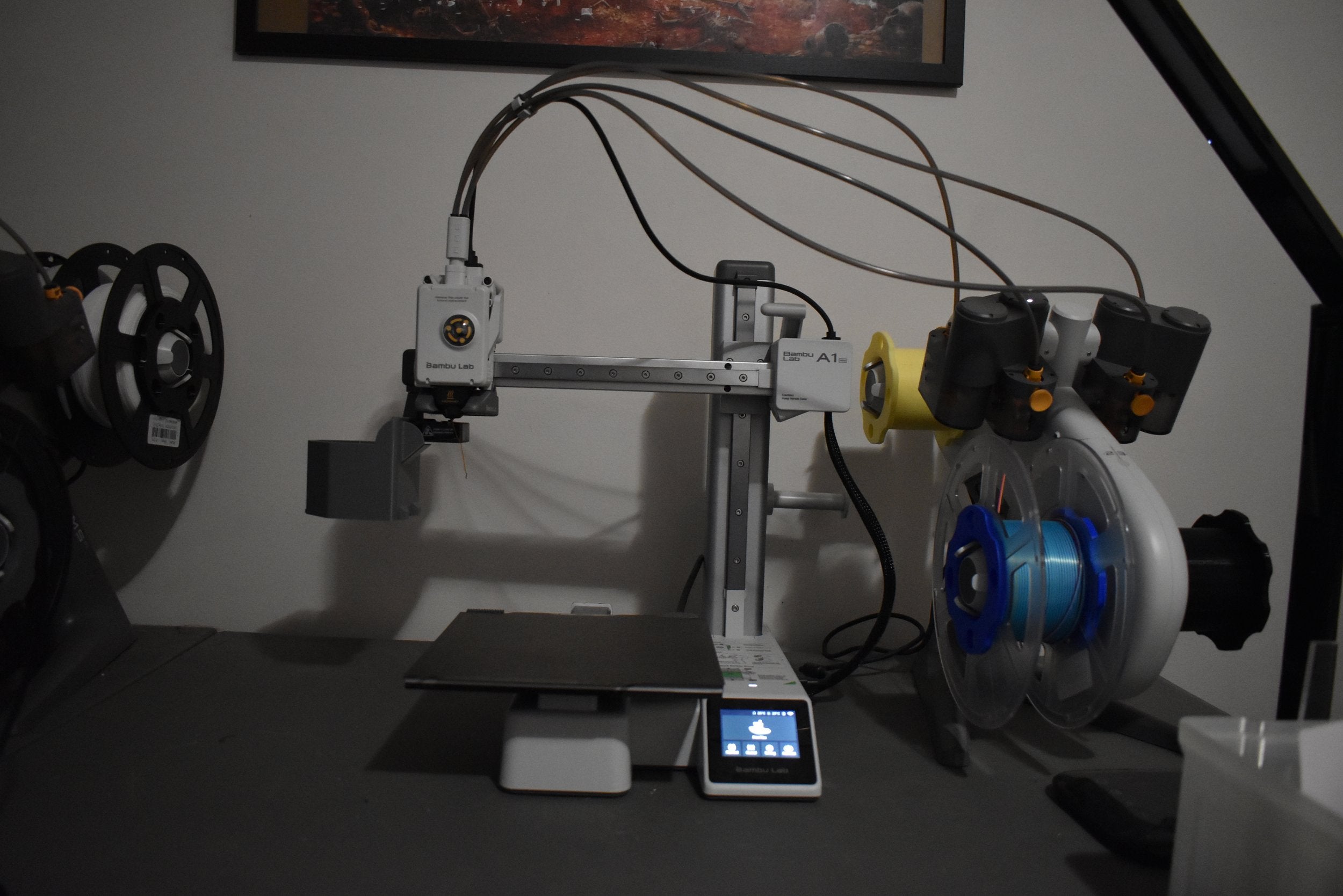 3D printer on a table with various tubes connected to it
