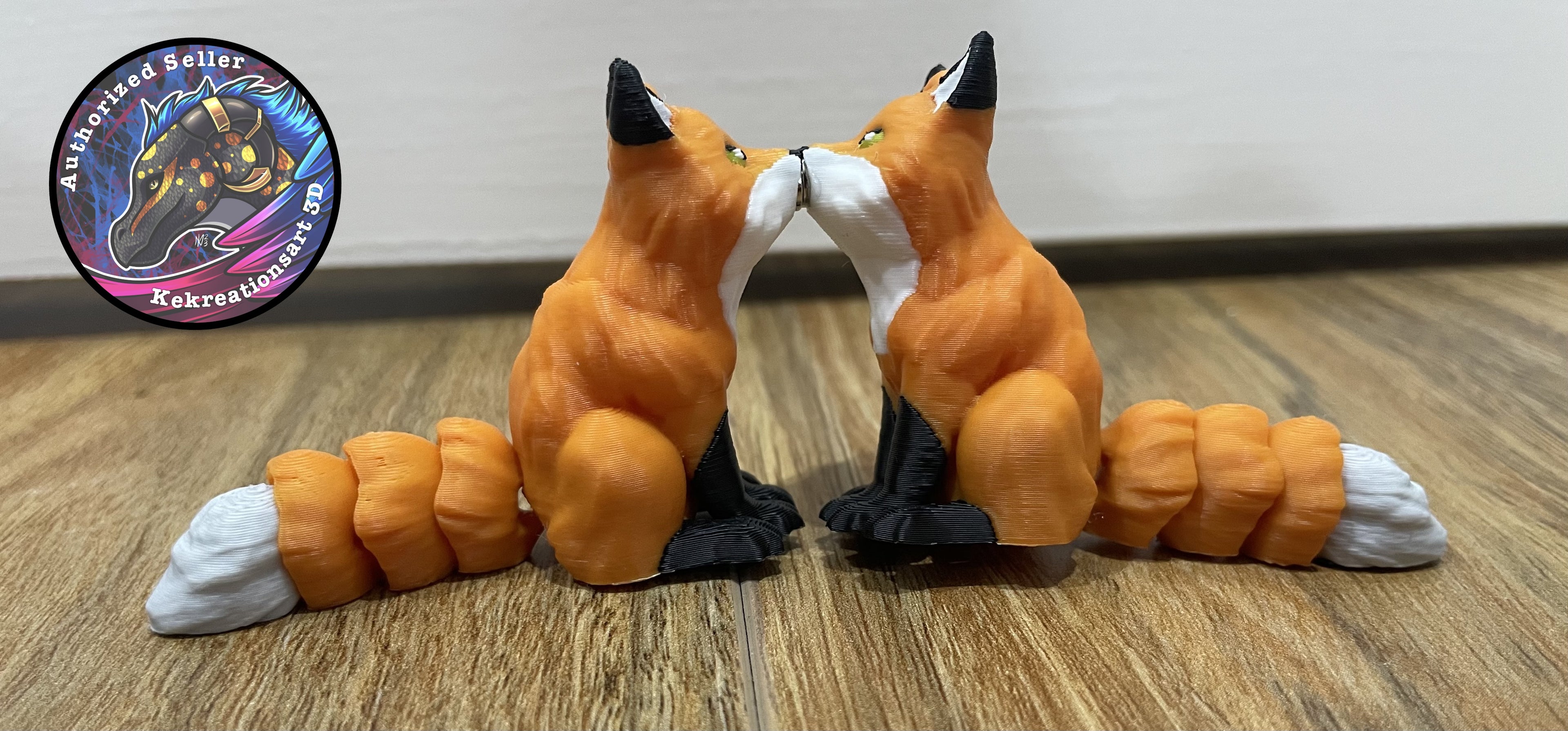 Two fox figurines facing each other on a wooden surface. There are magnets in their mouth, which the magnets are making the 2 foxes touch