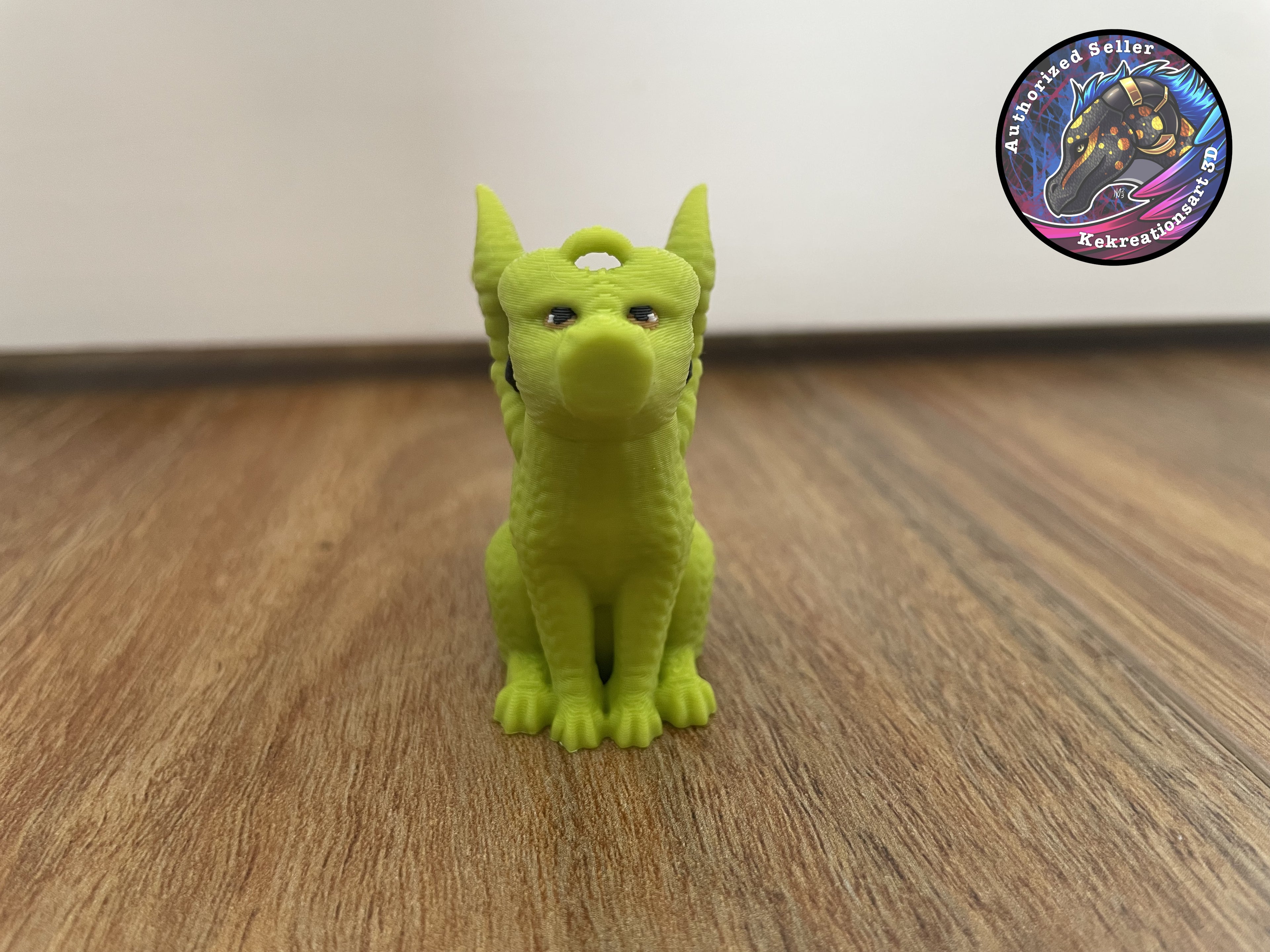 Green dragon figure on a wooden floor with a white wall background