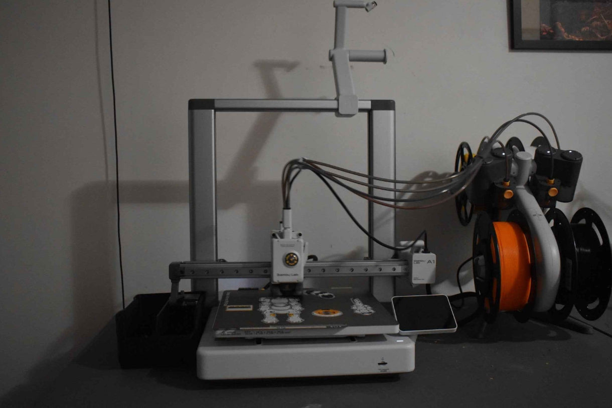 3D printer on a table with various tubes connected to it