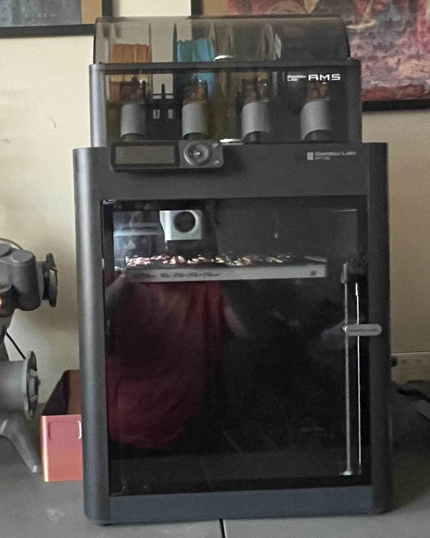Black 3D printer sitting on a desk