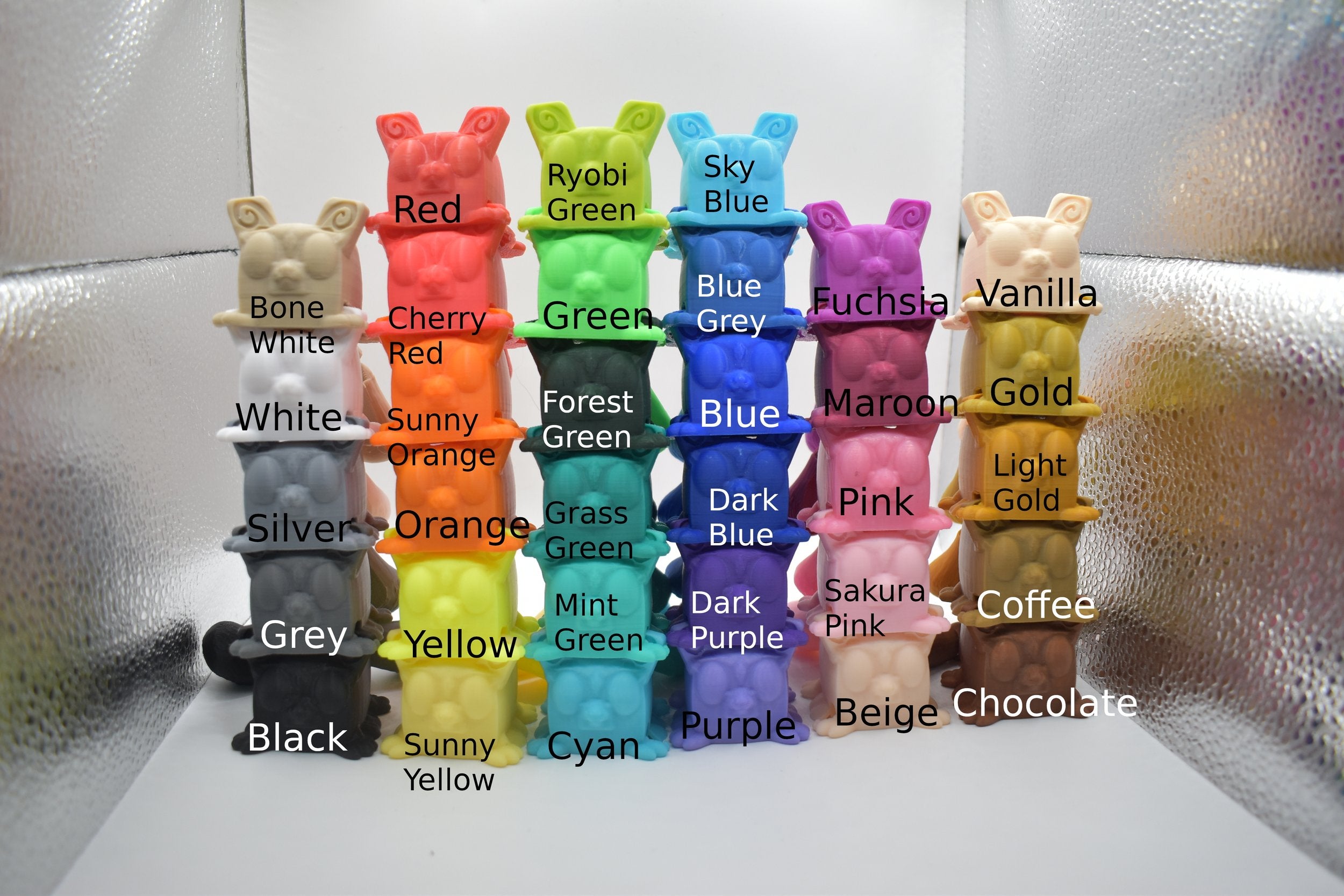 5/6 by 6 set of Sugarcube gliders, demonstrating various colours on a white and silver background. The text says "bone white", "White", "Silver", "Grey", "Black", "Red", "Cherry Red", "Sunny Orange", "Orange", "Yellow", "Sunny Yellow", "Ryobi Green", "Green", "Forest Green", "Grass Green", "Mint Green", "Cyan", "Sky Blue", "Blue Grey", "Blue", "Dark Blue", "Dark Purple", "Purple", "Fuchsia", "Maroon", "Pink", "Sakura Pink", "Beige", "Vanilla", "Gold", "Light Gold", "Coffee", and "Chocolate"